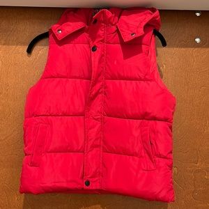 Red kids puffer vest with removable hood.